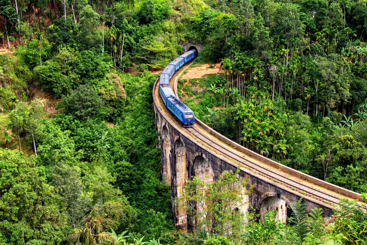 Blue train travelling through Sri Lanka's hill country